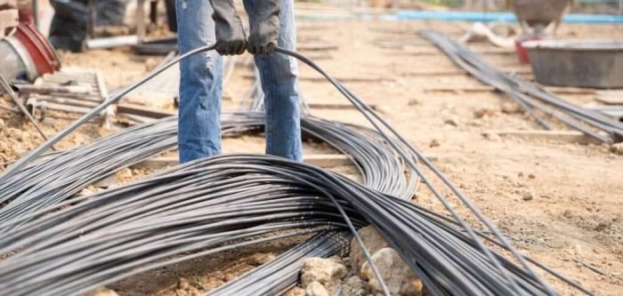 A group of steel rod tight by chain and lift up at construction site A group of steel rod tight by chain and lift up at construction site